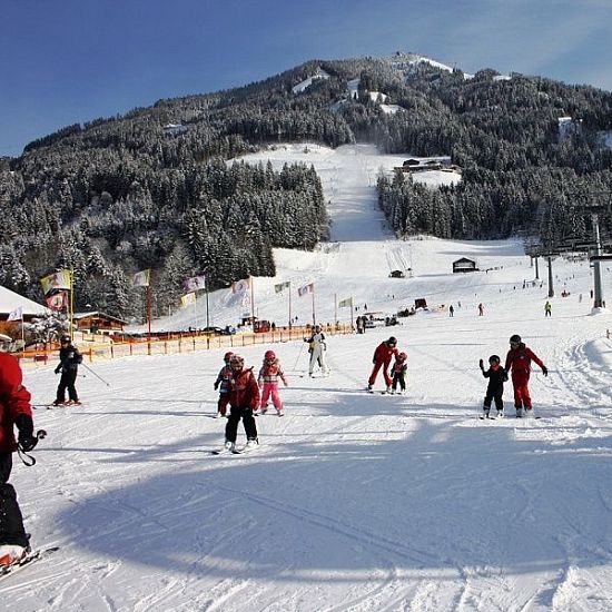 skiwelt-uebungswiese-mit-kindern-in-westendorf-mit-blick-auf-berg-10